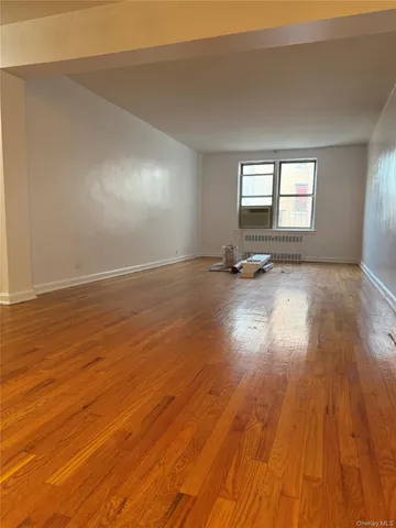 a view of a room with wooden floor and bathroom