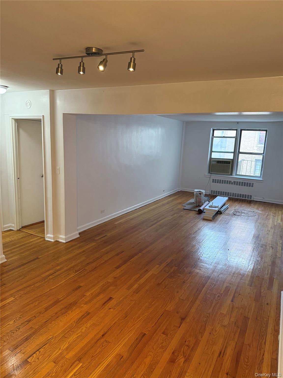 325 East 201st Street, Unit 3J Bronx, NY 10458 - Photo 13 of 33 a view of a room with wooden floor