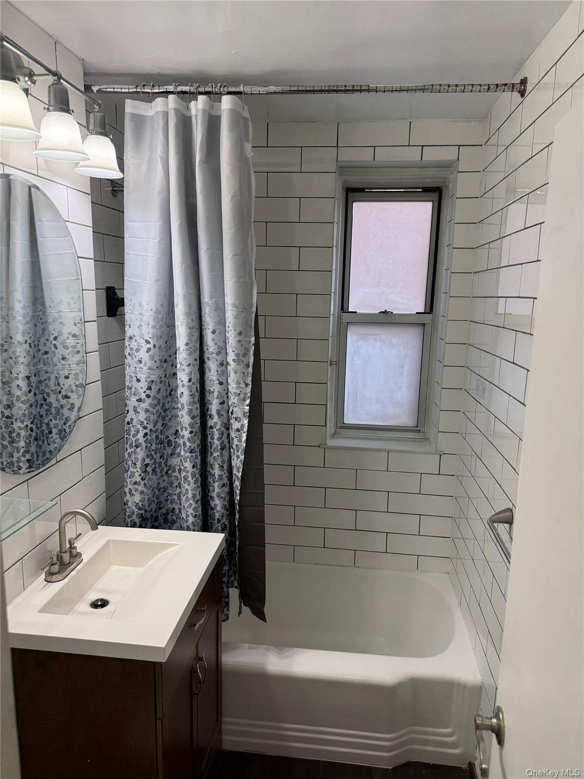 325 East 201st Street, Unit 3J Bronx, NY 10458 - Photo 22 of 33 a bathroom with a sink and a bathtub