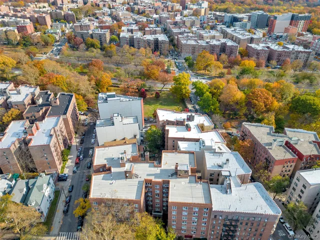 an aerial view of a residential apartment building with parking