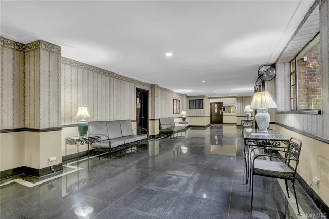 a open kitchen with stainless steel appliances granite countertop a stove a sink a dining table and chairs with wooden floor