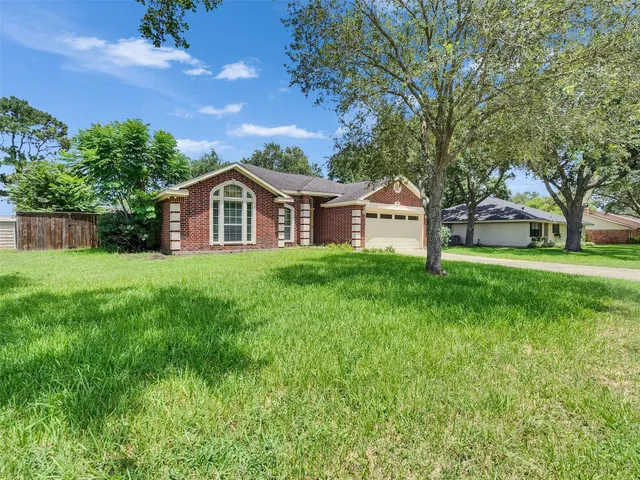 a front view of house with yard and green space