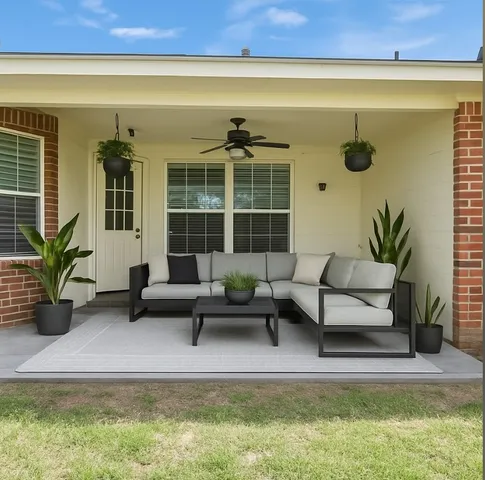 a building outdoor space with patio furniture and potted plant