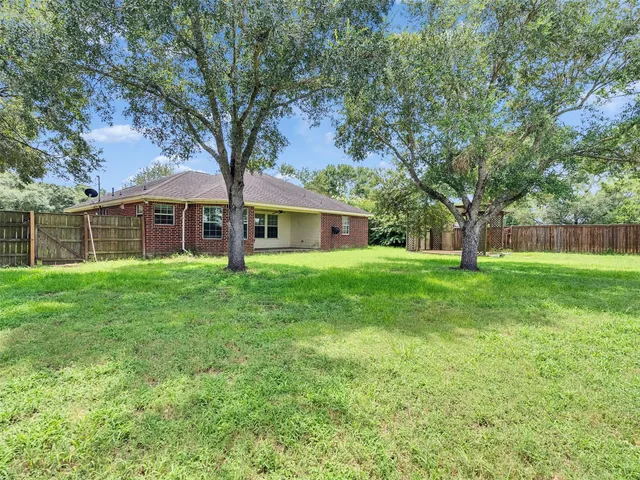 a front view of a house with yard and green space