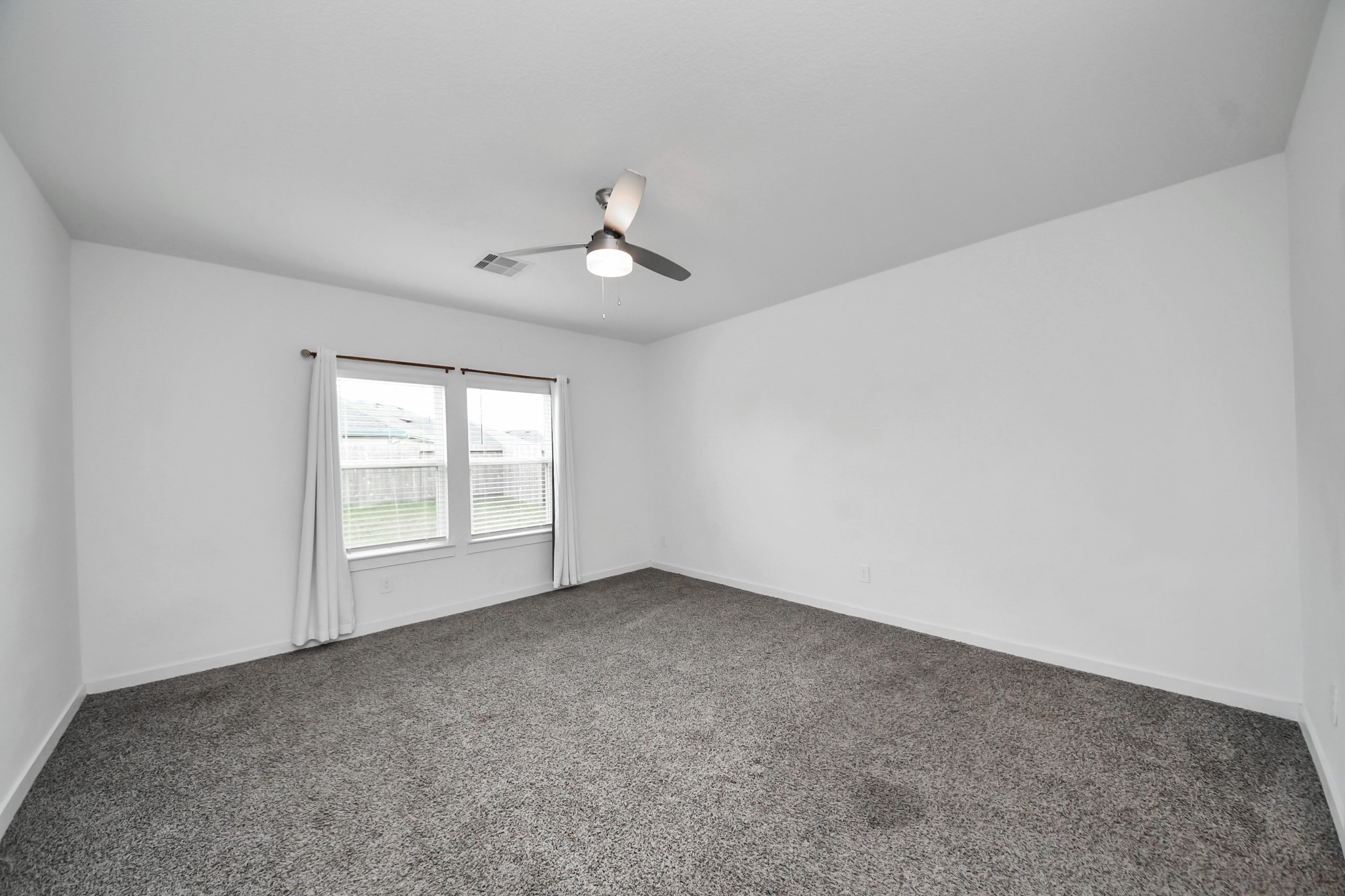 31738 Melkridge Road Fulshear, TX 77441 - Photo 15 of 33 Welcome to your Primary Suite with High Ceilings and Lush Carpeting to sink your toes into!
