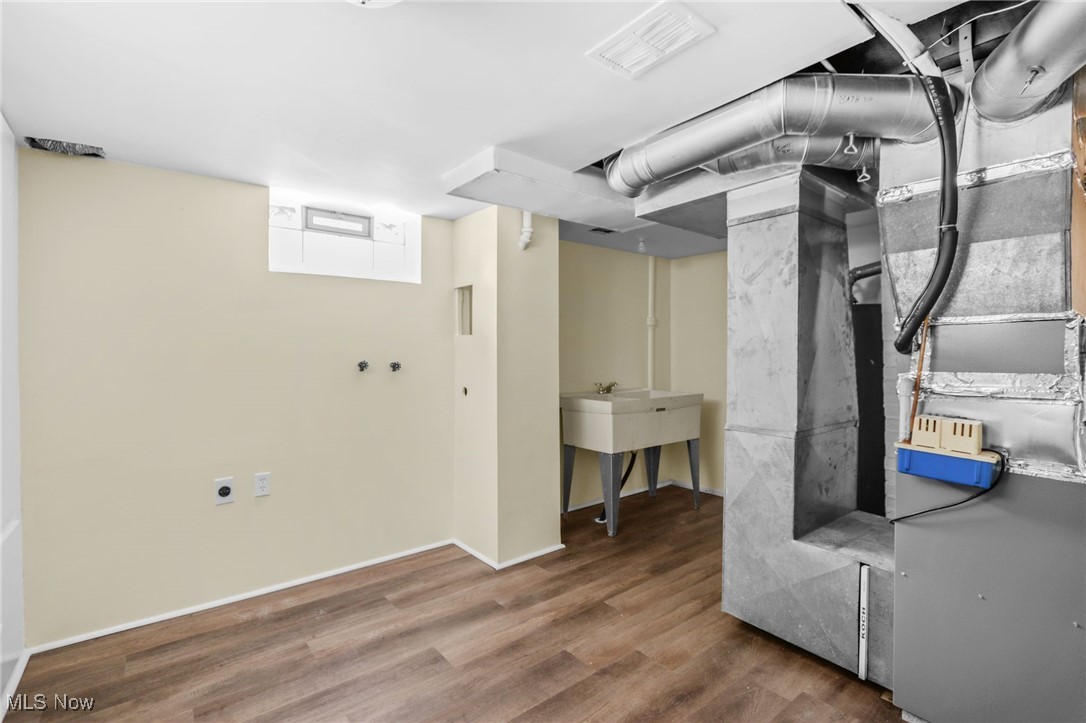 3205 George Avenue Cleveland, OH 44134 - Photo 29 of 32 Below grade area featuring wood finished floors and heating unit