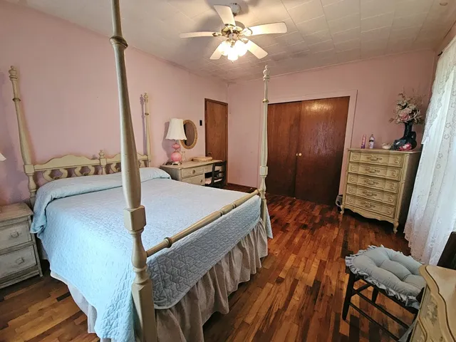 a bedroom with a bed and a window