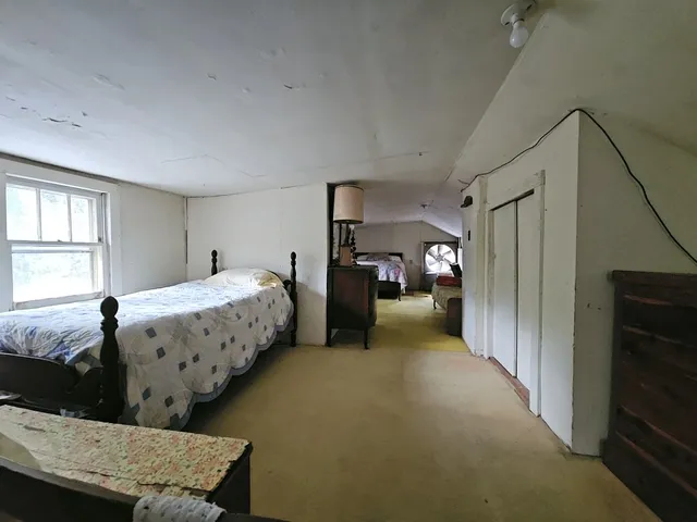 a bedroom with bed and window