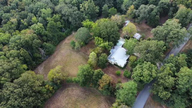 an aerial view of a house with a yard and outdoor seating