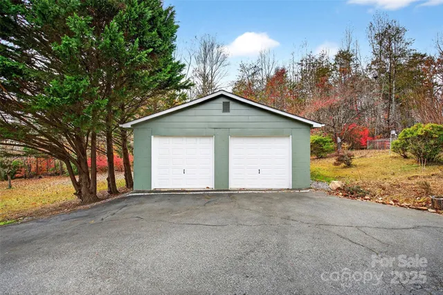 a view of a house with a yard and garage