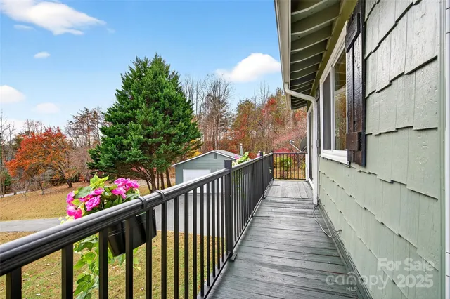 a view of a balcony with wooden floor and fence