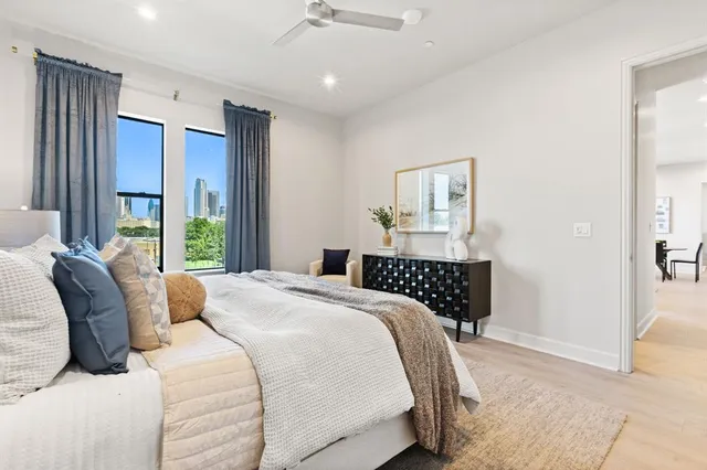 a bedroom with a large bed and a large window