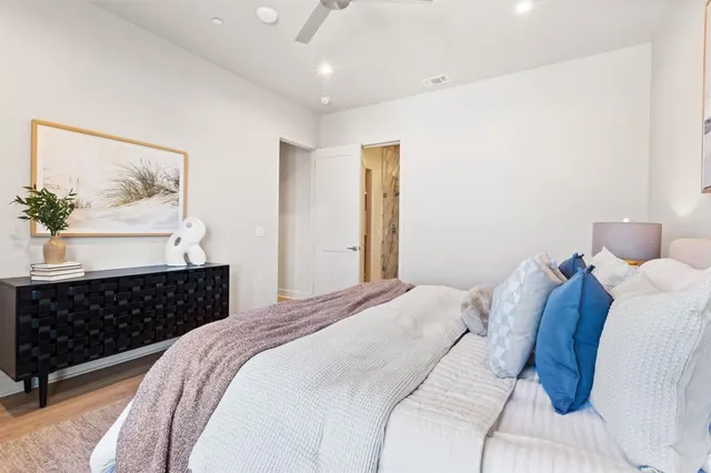 a bedroom with a bed and a painting on the wall