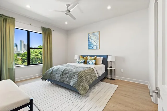 a bedroom with a large bed and a window