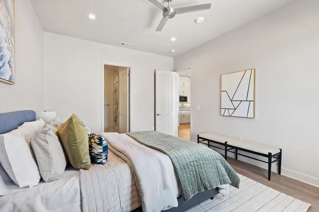 a bedroom with a bed and wooden floor