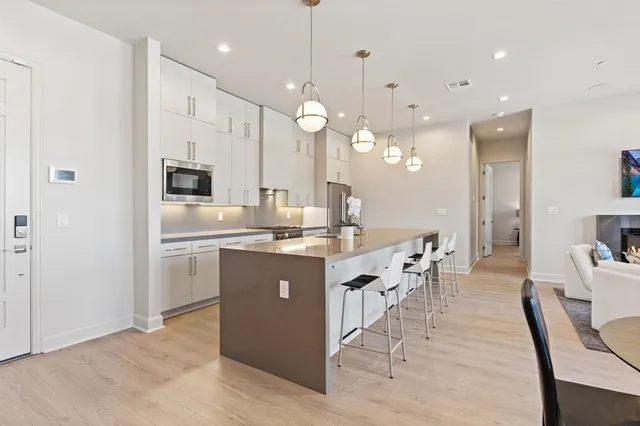 a kitchen with kitchen island a sink cabinets and wooden floor