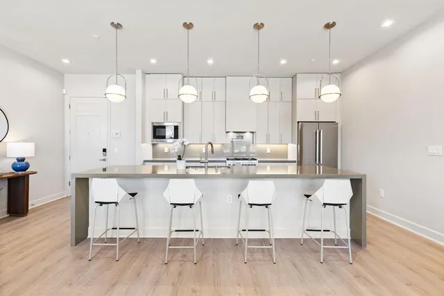 a large kitchen with a table and chairs