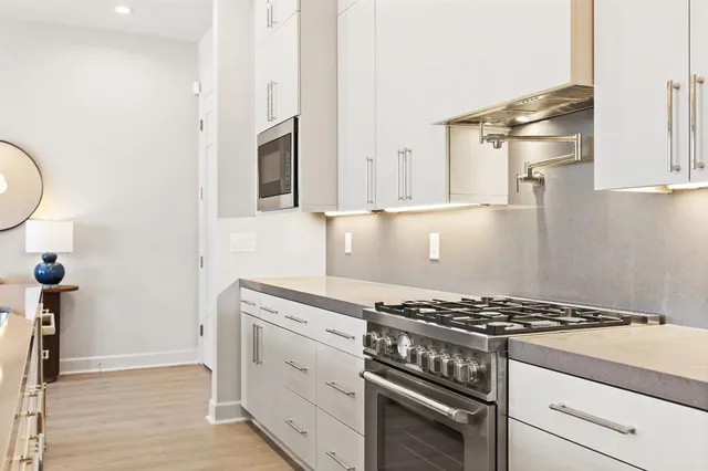 a kitchen with granite countertop a stove and a sink
