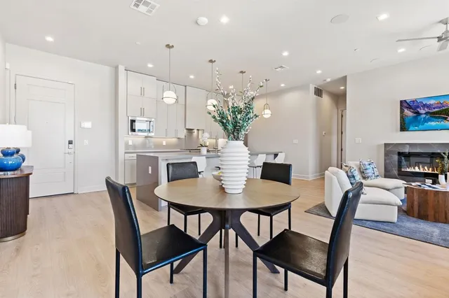 a view of a dining room with furniture and wooden floor