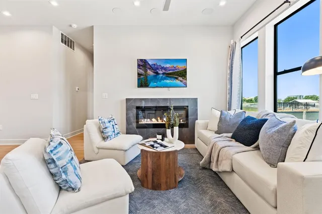 a living room with furniture two window and a fireplace