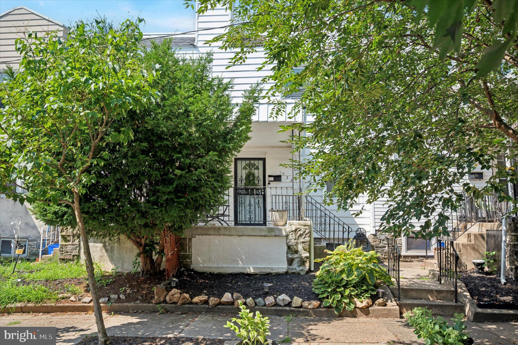 1052 Edgemore Road Philadelphia, PA 19151 - Photo 1 of 24 Charming entrance framed by lush greenery.