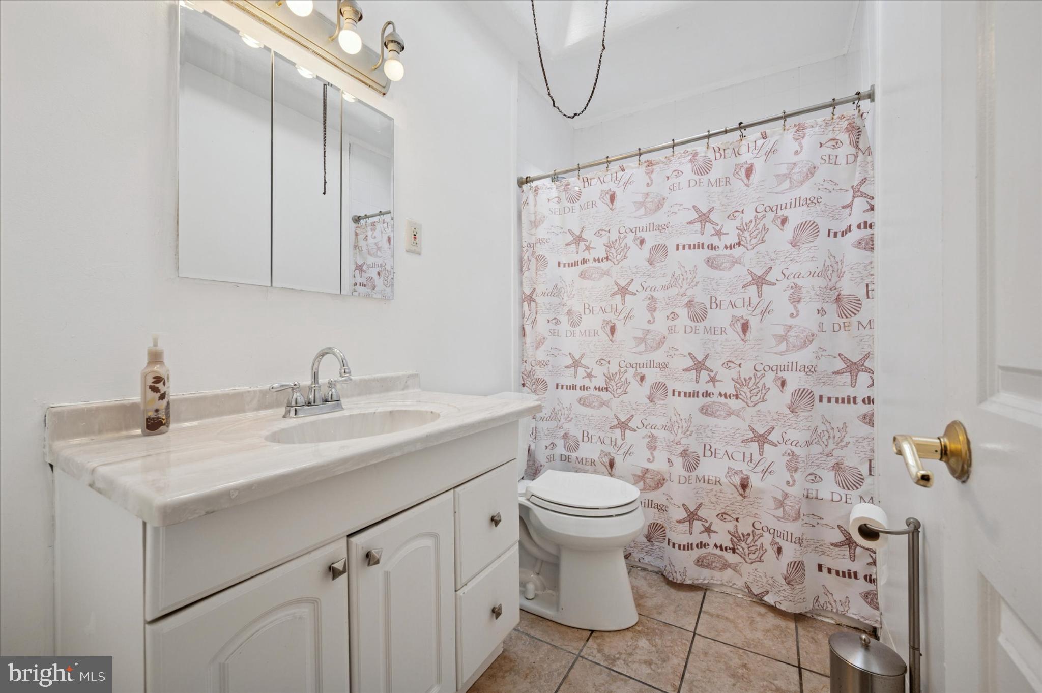 1052 Edgemore Road Philadelphia, PA 19151 - Photo 12 of 24 Coastal charm in a serene bathroom retreat.