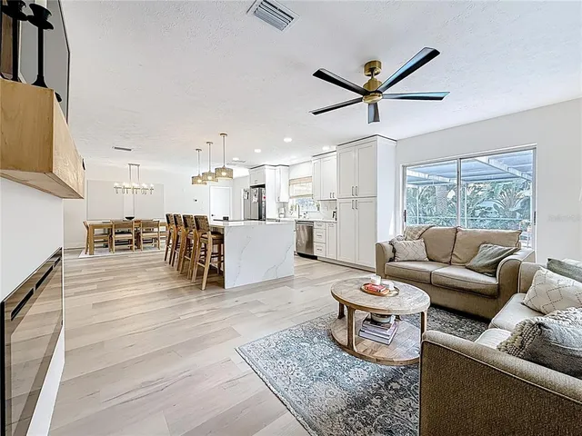 a living room with furniture and kitchen view