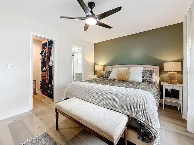 a bedroom with a bed and a ceiling fan