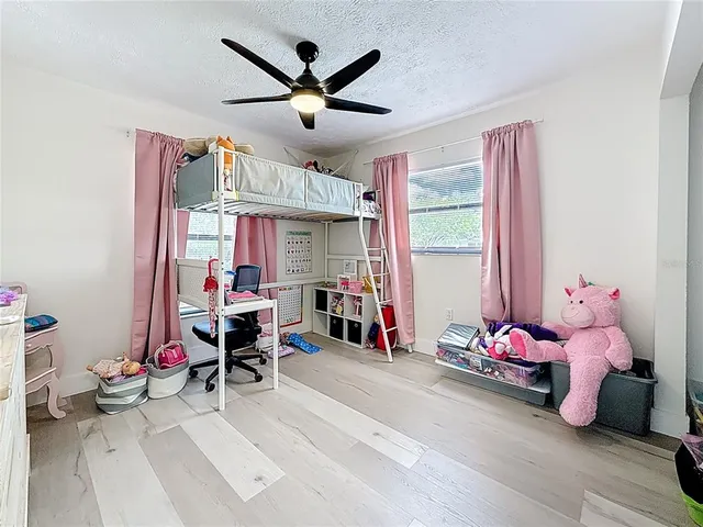 a bedroom with furniture and a large window
