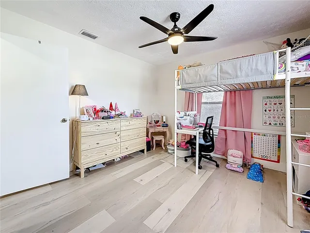 a bed room with a bed and a desk