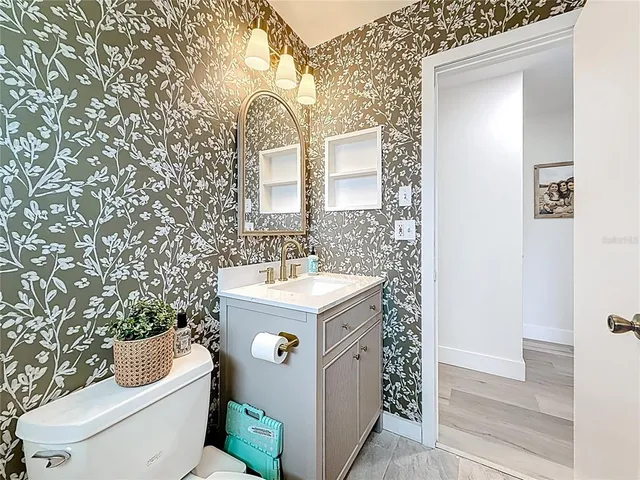 a bathroom with a sink toilet and mirror