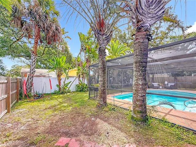 a view of backyard with sink and wooden fence
