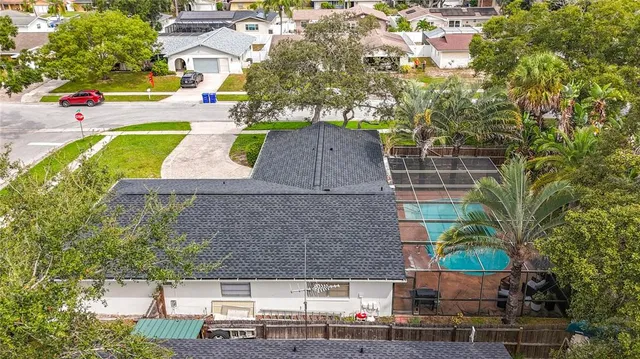 an aerial view of a house with a yard and lake view
