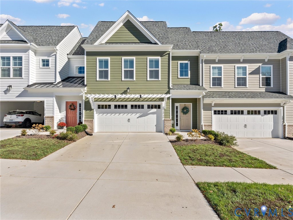 13736 Randolph Pond Lane Midlothian, VA 23114 - Photo 1 of 37 a front view of a house with a yard and garage