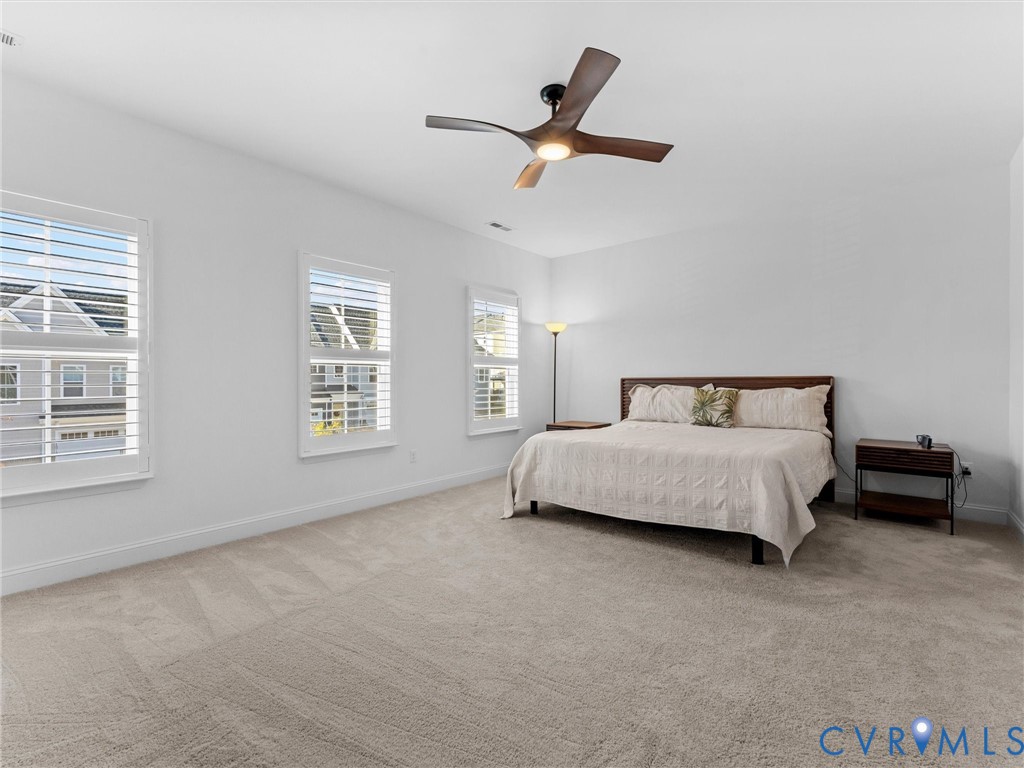 13736 Randolph Pond Lane Midlothian, VA 23114 - Photo 20 of 37 a spacious bedroom with a bed and a window