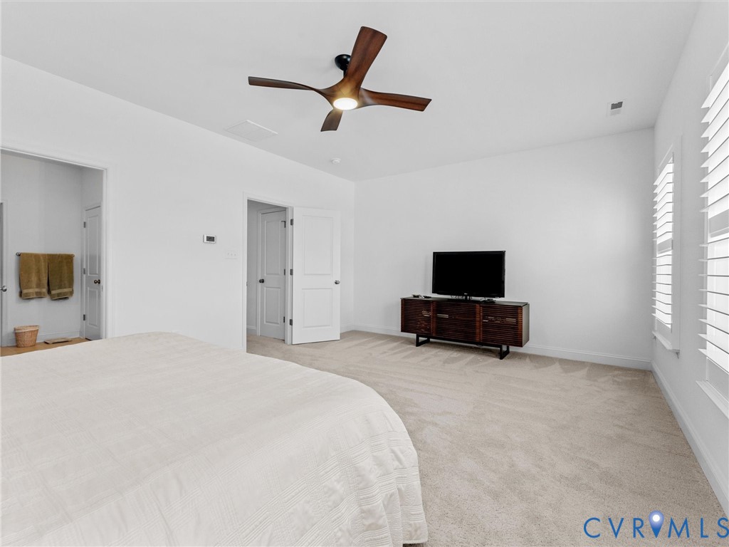 13736 Randolph Pond Lane Midlothian, VA 23114 - Photo 21 of 37 a bed room with a bed a flat screen tv and a couch