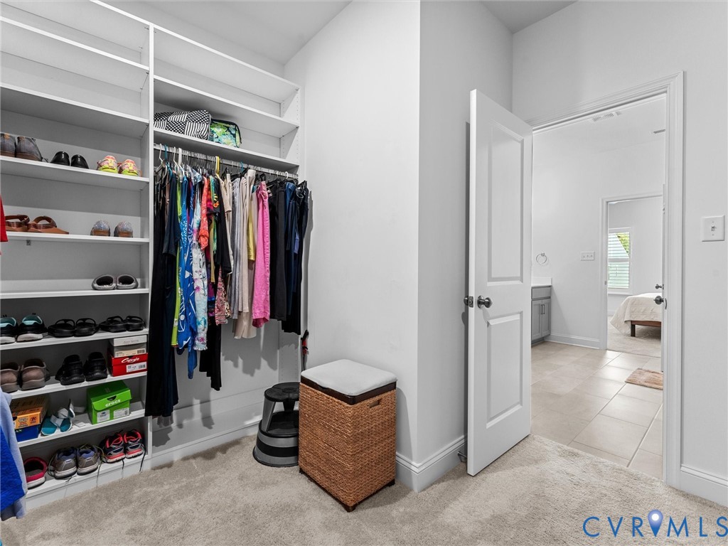 13736 Randolph Pond Lane Midlothian, VA 23114 - Photo 24 of 37 a view of walk in closet with clothes and shoes