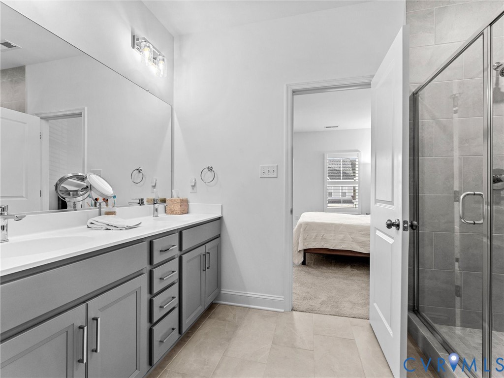 13736 Randolph Pond Lane Midlothian, VA 23114 - Photo 33 of 37 a en suite bathroom with a double vanity sink a mirror and a shower