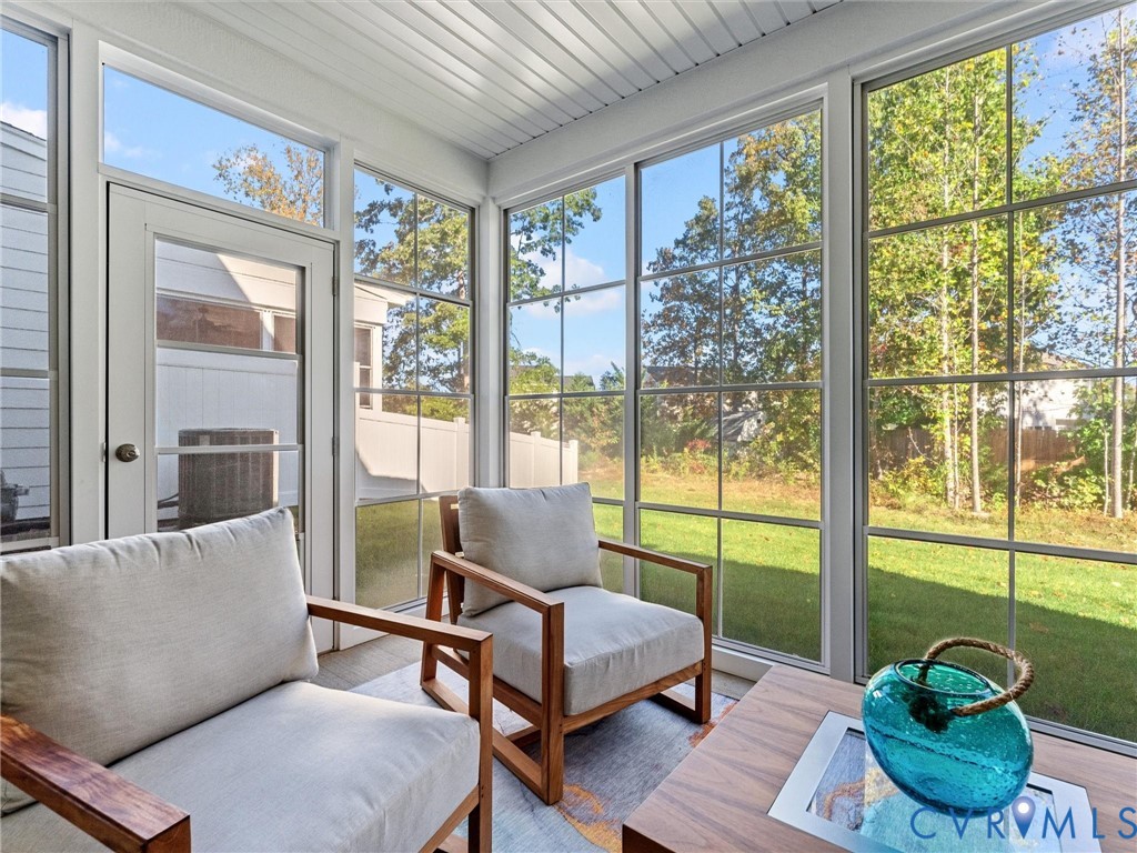 13736 Randolph Pond Lane Midlothian, VA 23114 - Photo 35 of 37 a living room with furniture and a floor to ceiling window