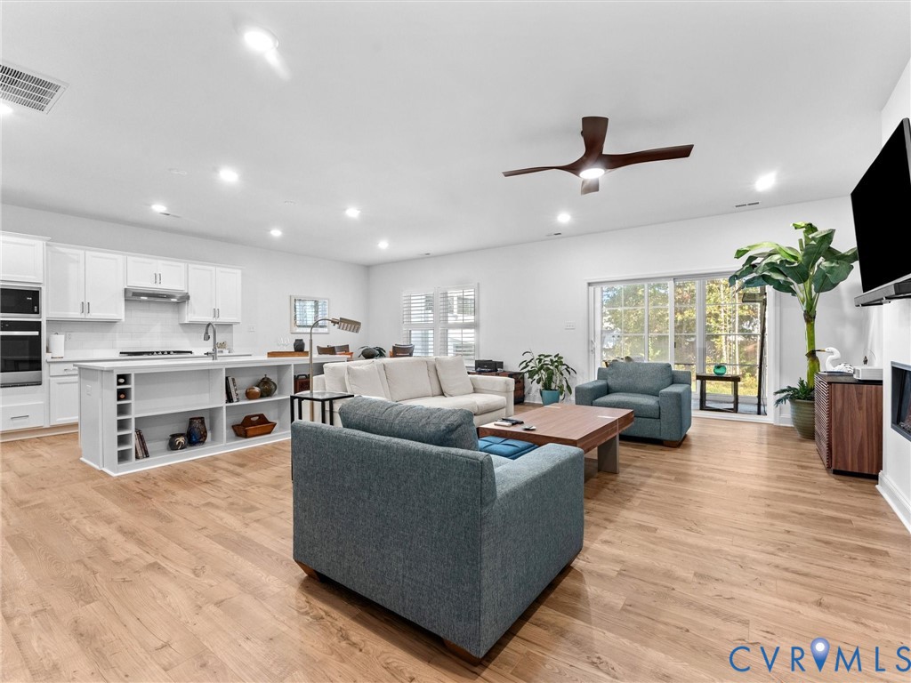 13736 Randolph Pond Lane Midlothian, VA 23114 - Photo 5 of 37 a living room with furniture kitchen view and a wooden floor
