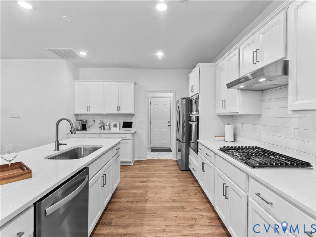 13736 Randolph Pond Lane Midlothian, VA 23114 - Photo 9 of 37 a kitchen with kitchen island stainless steel appliances a sink stove and cabinets