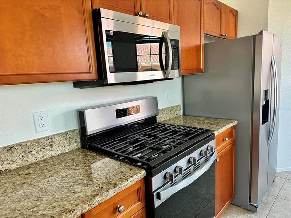 a stove top oven sitting inside of a kitchen