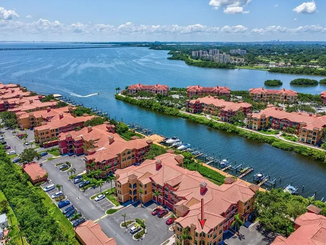 an aerial view of water body with boats and residential houses with outdoor space