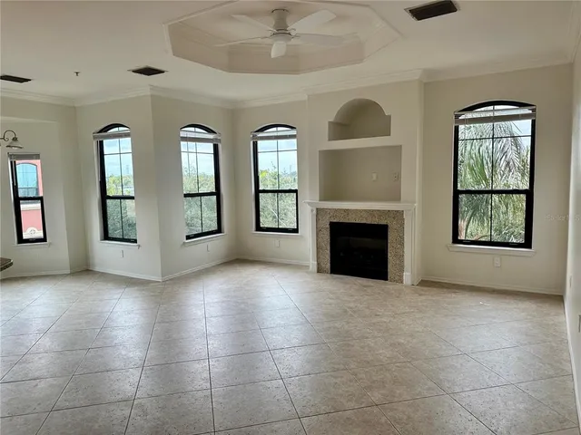 a view of an empty room with a fireplace and a window
