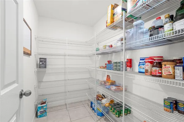 a kitchen with stainless steel appliances granite countertop a sink counter space cabinets and a view of living room