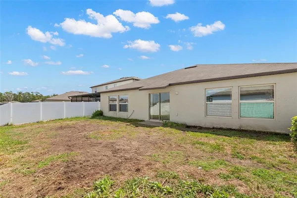 a spacious bedroom with a bed and a ceiling fan