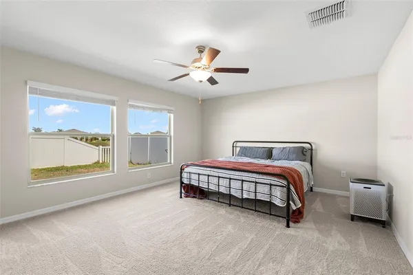 a bedroom with a large bed and a window