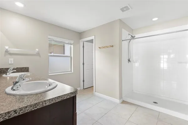 a bathroom with a granite countertop sink a mirror and a