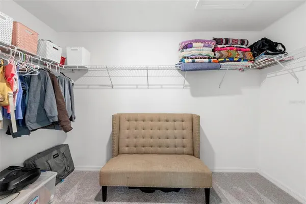 a bedroom with a bed and a ceiling fan