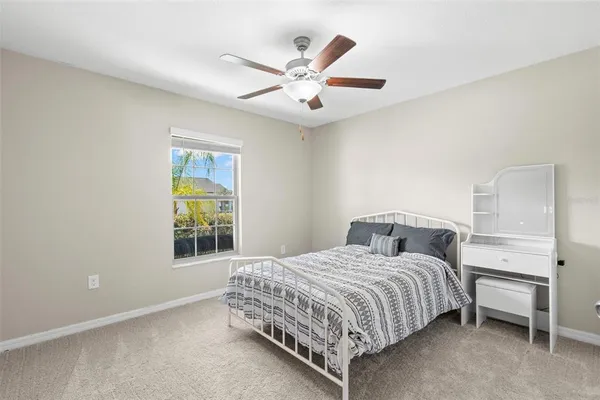 a bathroom with a granite countertop sink a large mirror and toilet